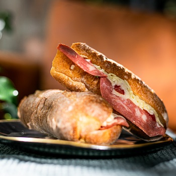 side view of sandwichs with sausage and cheese on plate